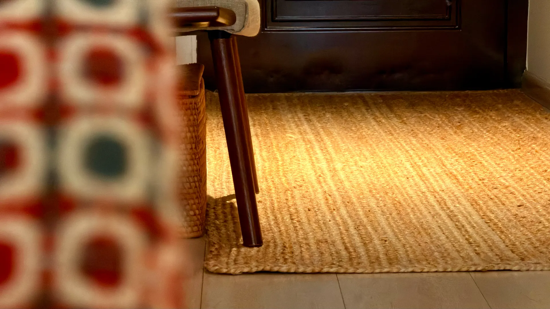 Plain handwoven jute underfoot, running to the edge where it meets pale tile