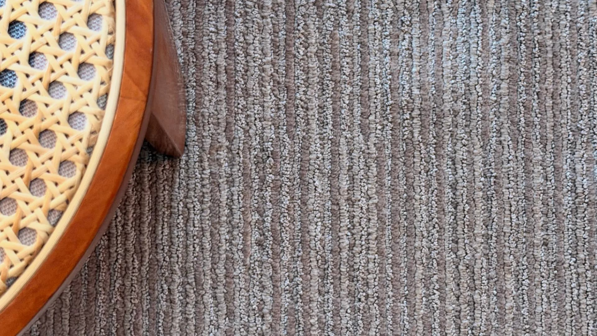 Close on the wool pile, fine linear ribbing running the length of the rug