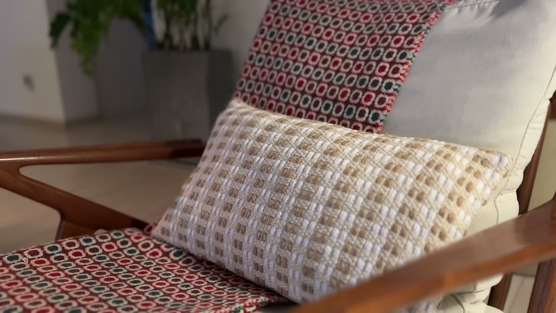 Geometric woven cushions styled on the wooden armchair
